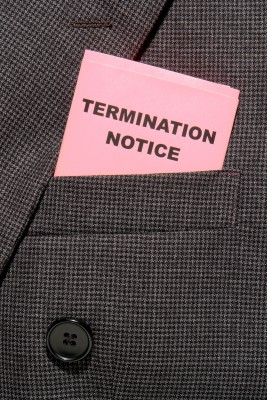 A pink termination notice slip in tucked in someones coat sleeve